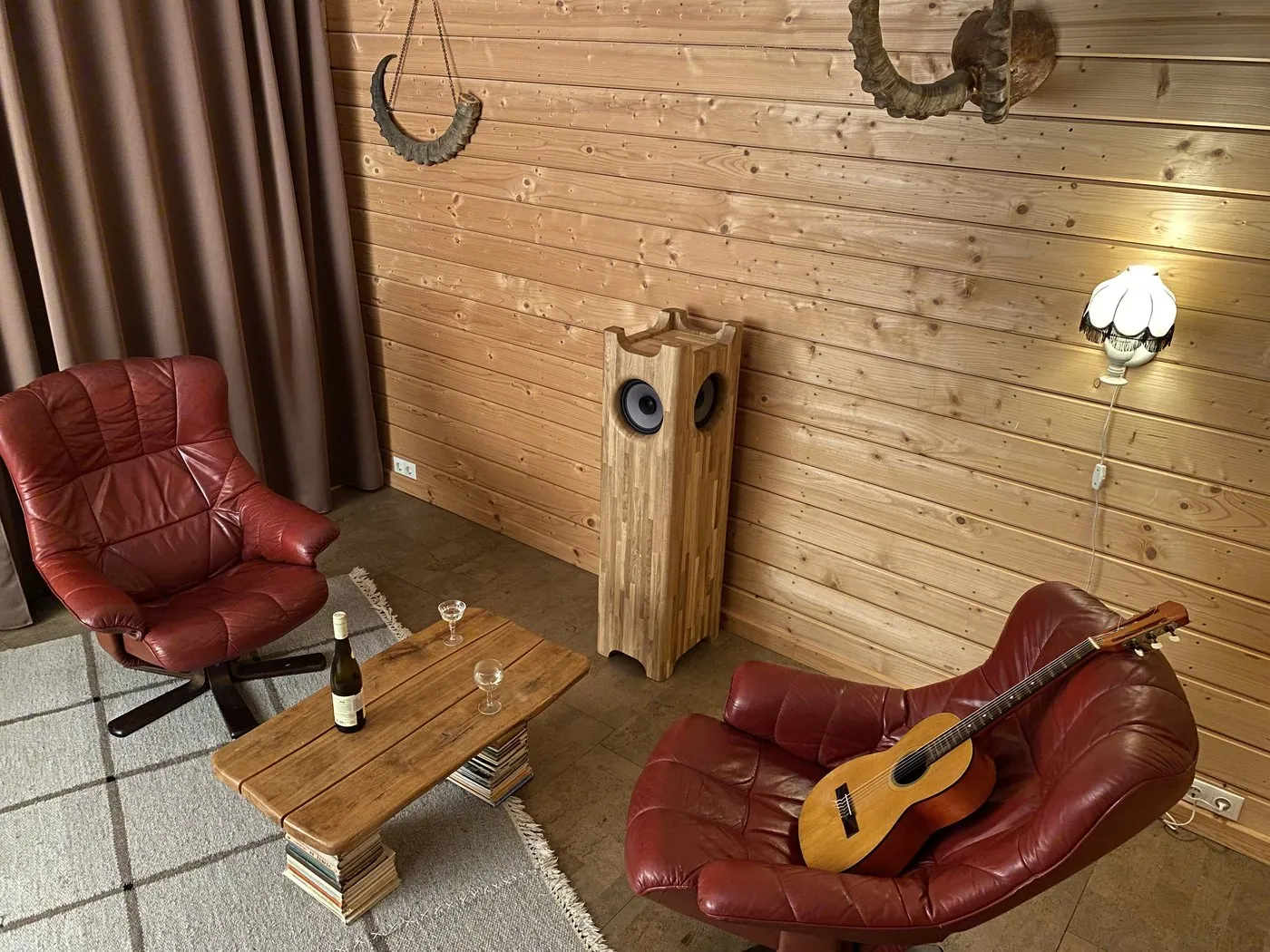 Single Speaker Stereo system in a wood-panelled listening room